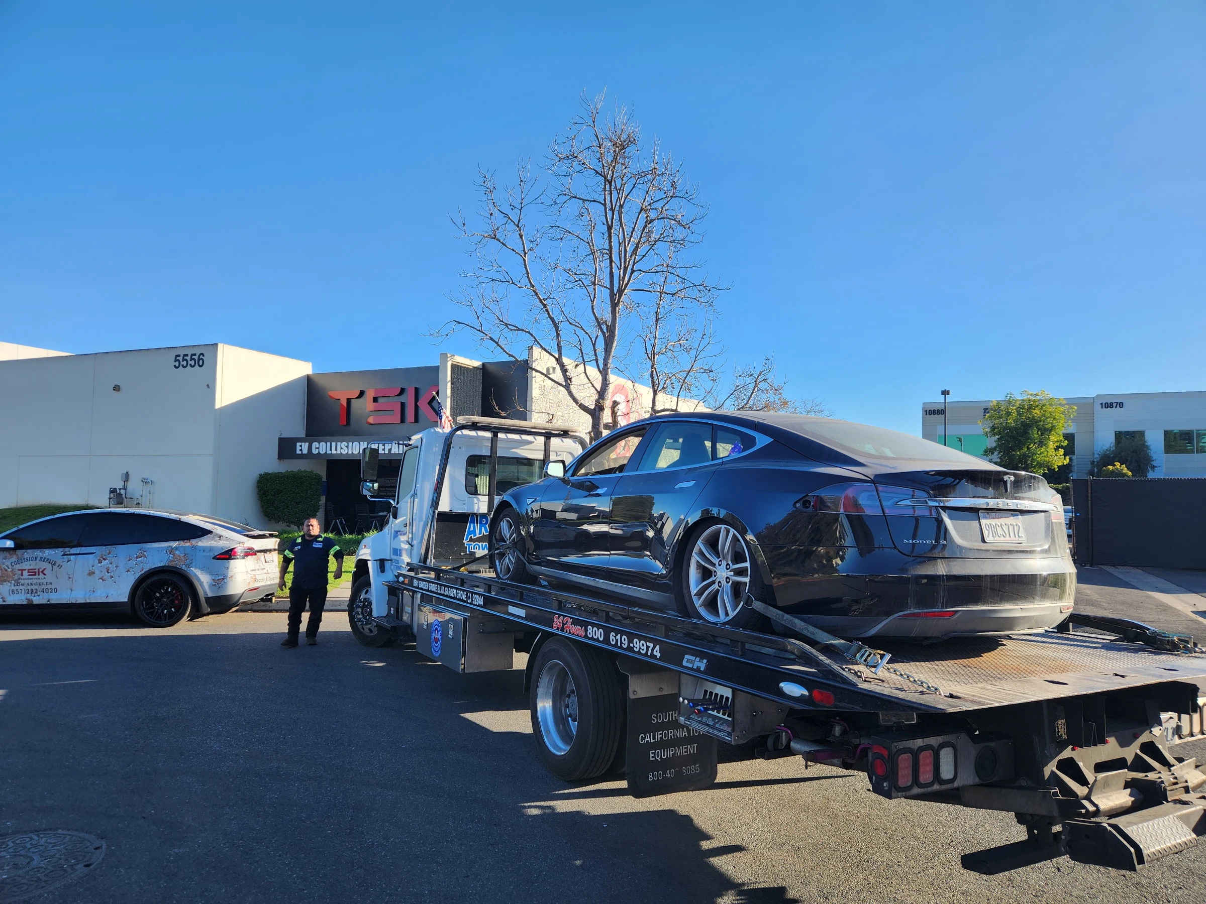 Tesla Model S arriving on a tow truck at TSK EV Collision Repair
