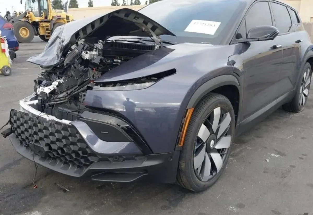 Fisker Ocean with front-end collision damage and exposed engine bay before repair at TSK