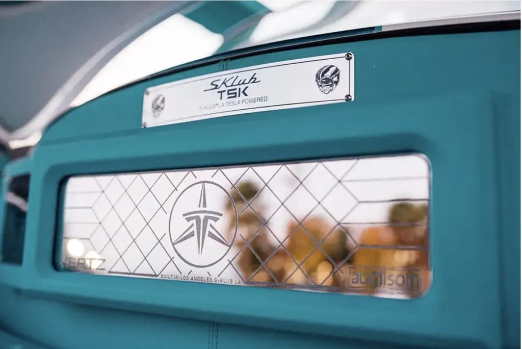 Tesla Gullwing project: S-Klub TSK plaque and a patterned mesh window on the teal interior