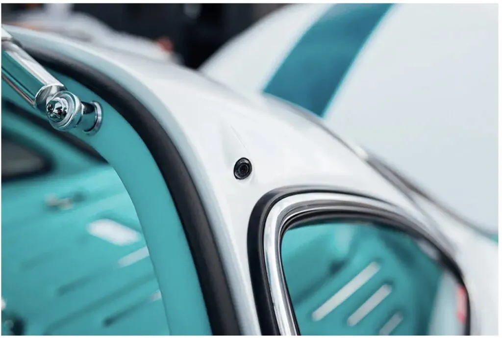 Tesla Gullwing project: close-up of the white body, chrome window trim and teal interior