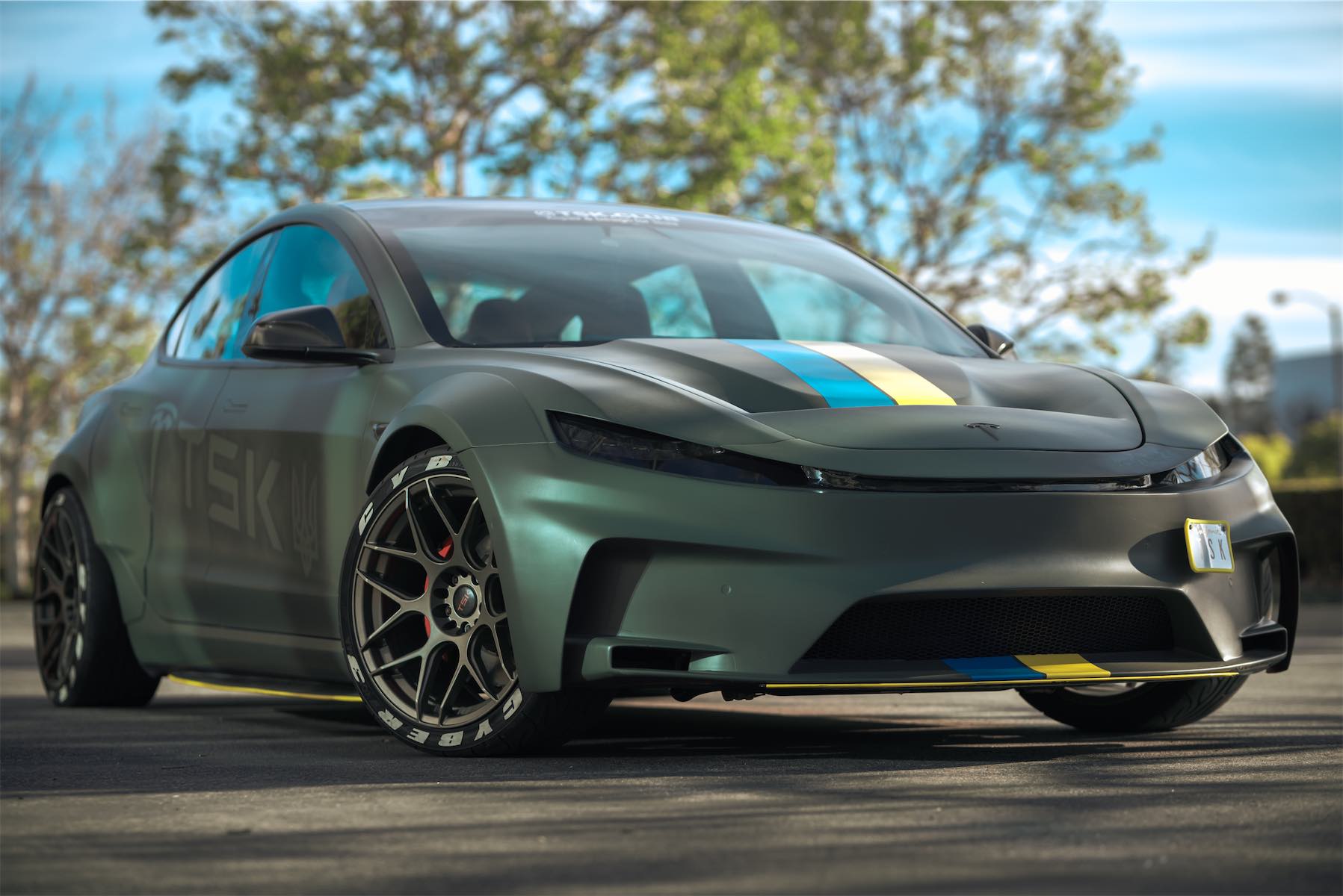 Cyber 3 project: matte green Tesla Model 3 with TSK livery, blue and yellow stripes and bronze wheels