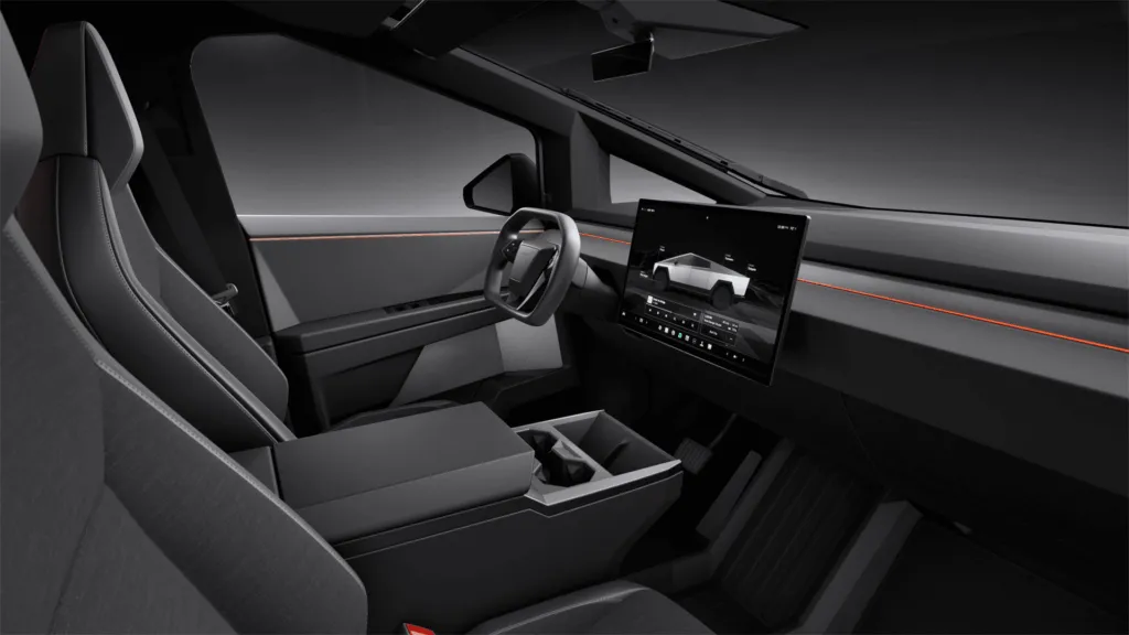 Tesla Cybertruck interior with rectangular steering wheel, center touchscreen and gray dashboard