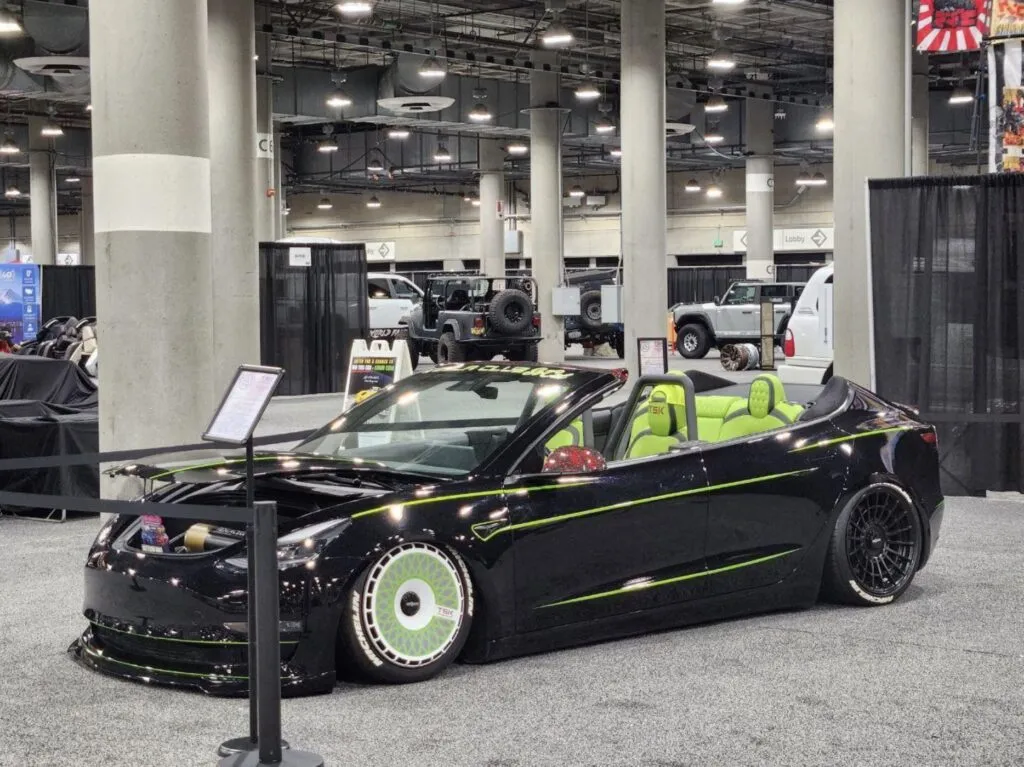 Roofless Tesla project: black Tesla Model 3 convertible with green stripes and TSK wheel covers at the LA Auto Show