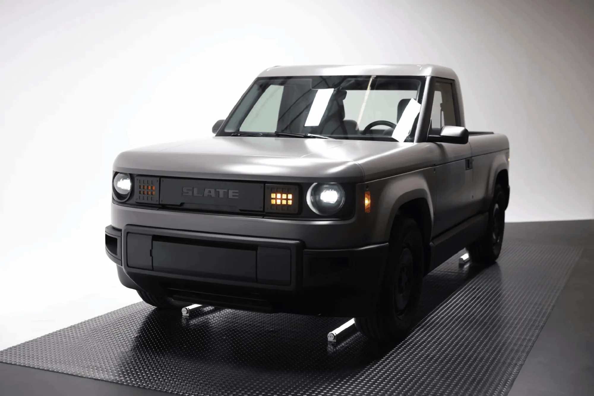 Slate electric pickup truck, gray, no-frills open cab, studio display