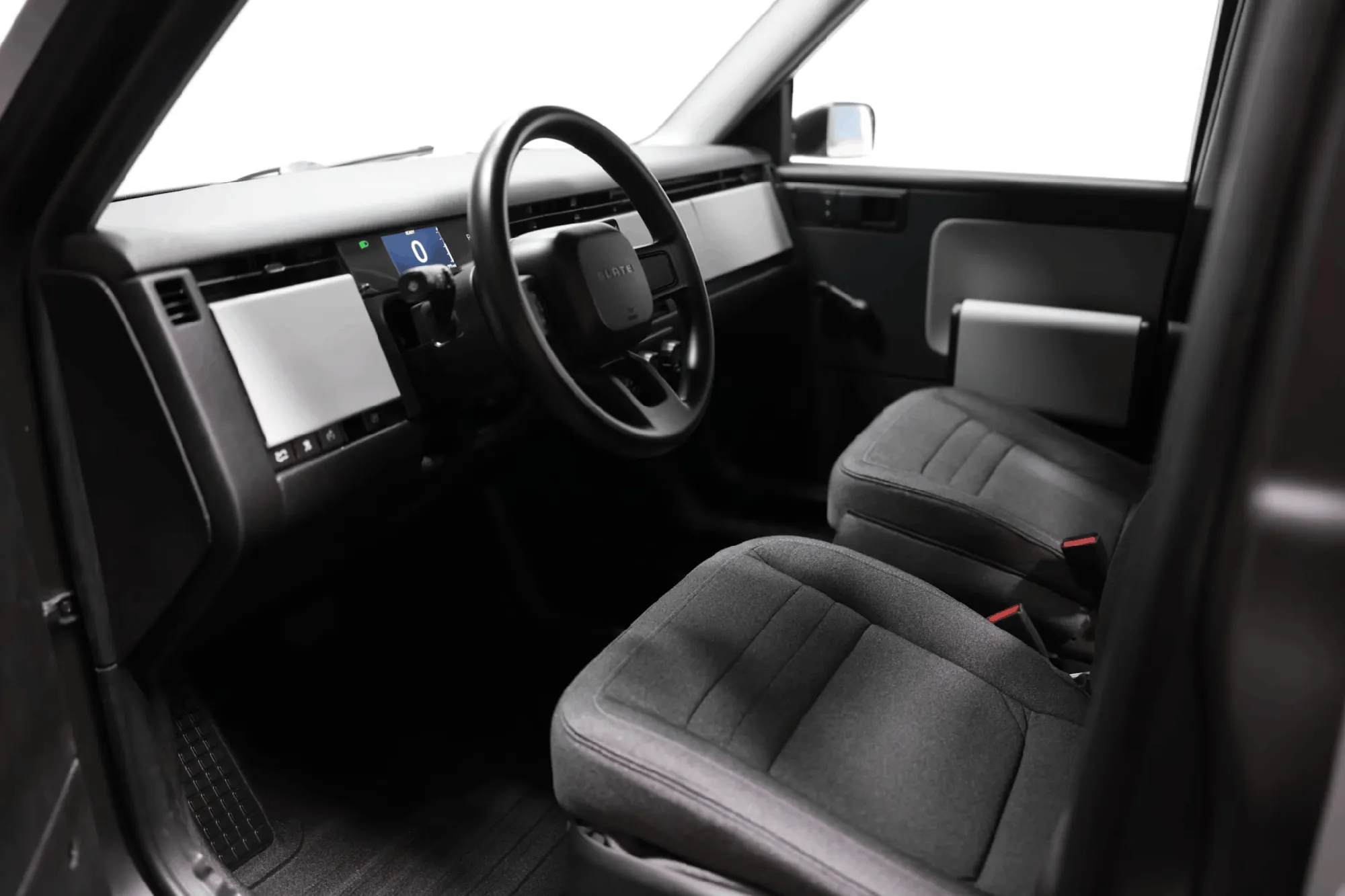 Slate Truck interior showing minimalist dashboard, digital display, and cloth front seats