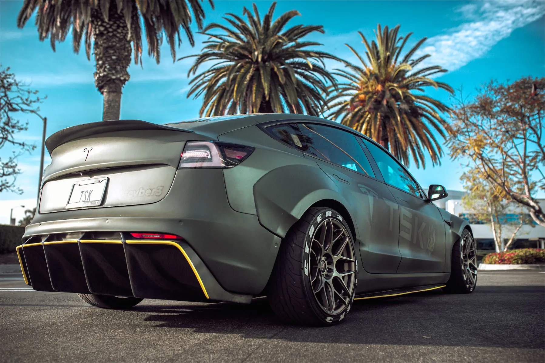 Cyber 3 project: rear of the matte green Model 3 widebody with its diffuser