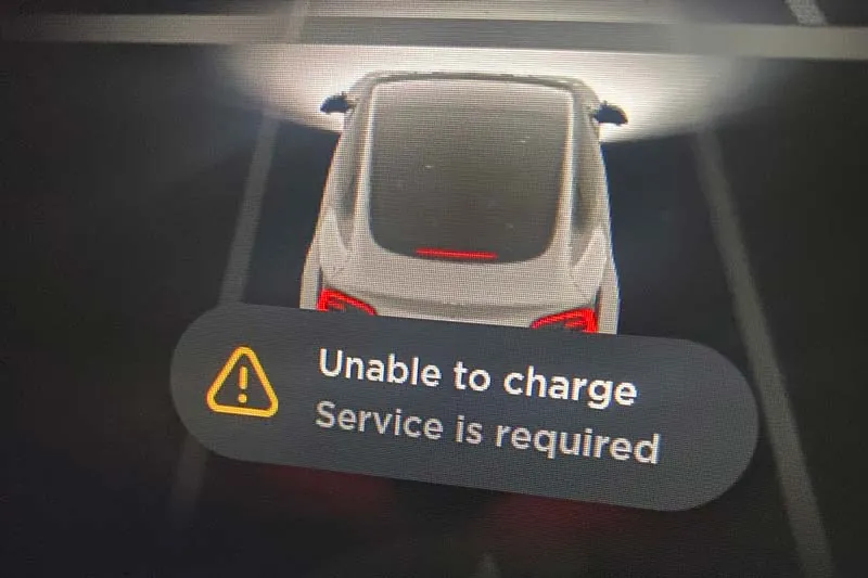 Tesla dashboard screen showing "Unable to charge, Service is required" warning message
