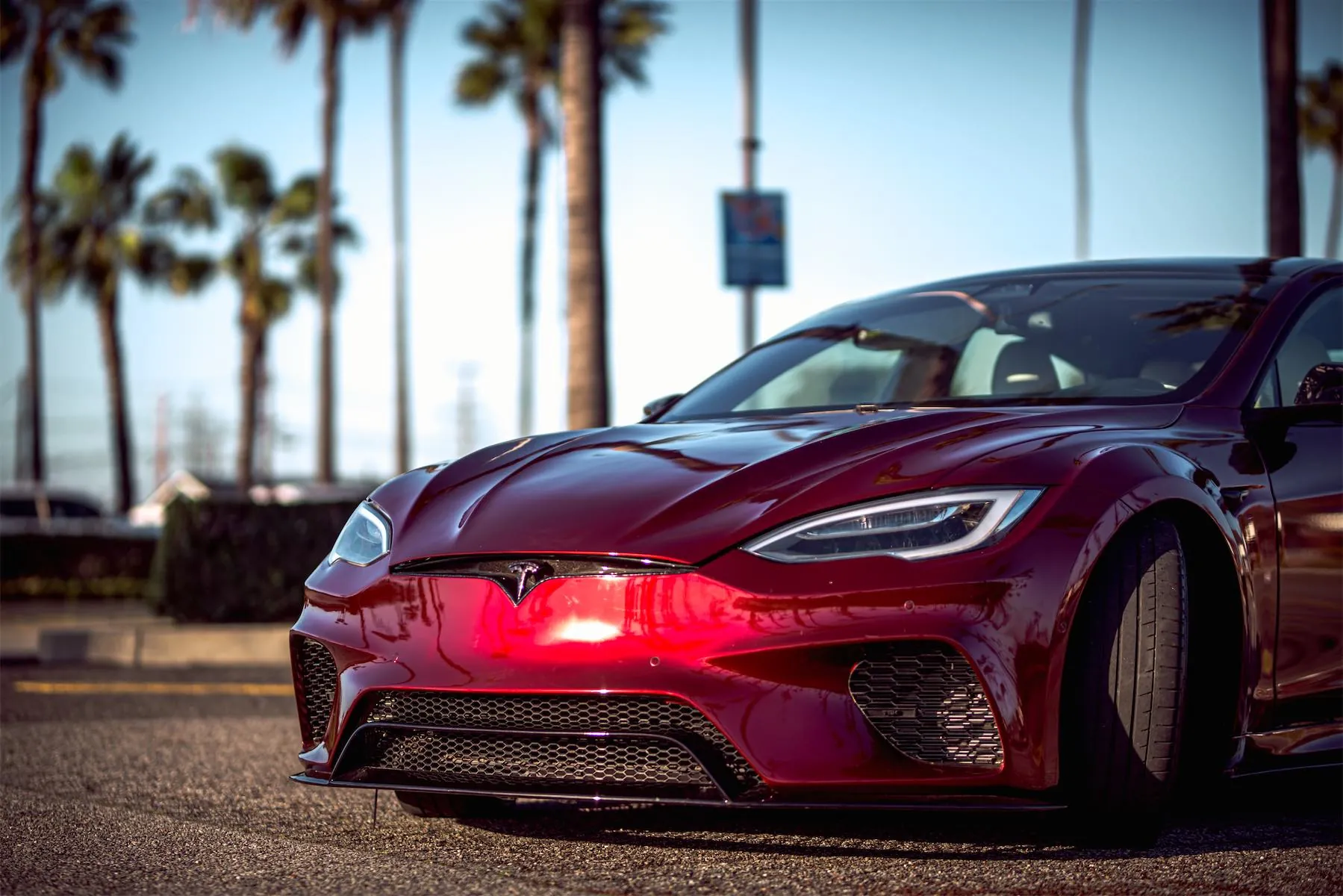 Wild Tesla project: front end of the dark red Tesla Model S widebody in a parking lot