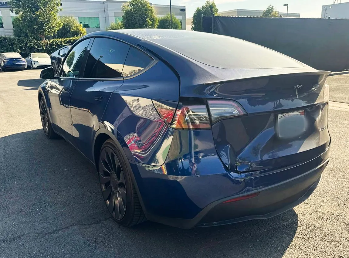 Dark blue Tesla Model Y rear bumper damage before collision repair at TSK