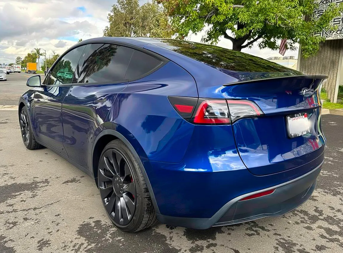 Rear view of blue Tesla Model Y after collision repair at TSK, Cypress