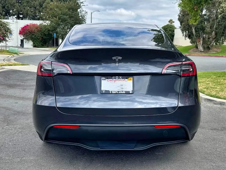 Rear view of dark Tesla Model Y after collision repair at TSK, Cypress
