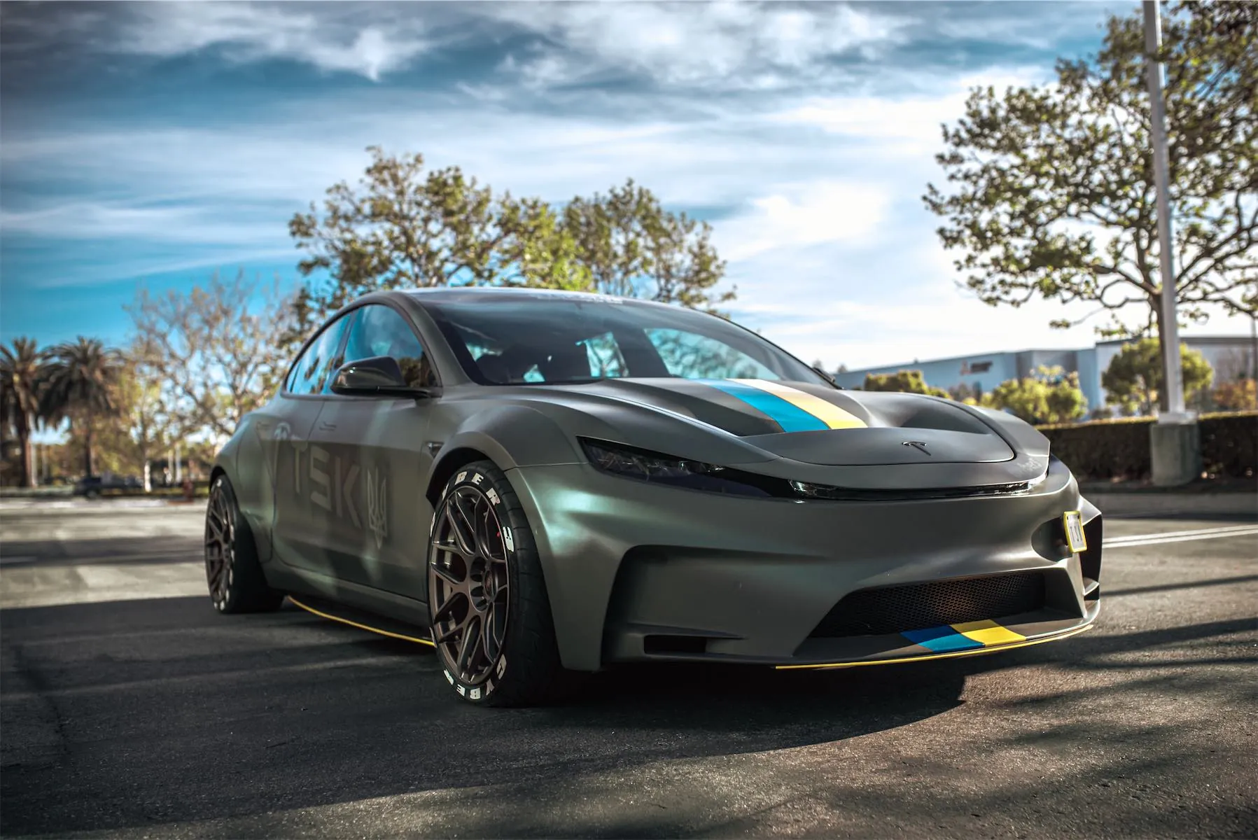 Cyber 3 project: matte green Tesla Model 3 widebody with blue and yellow racing stripes