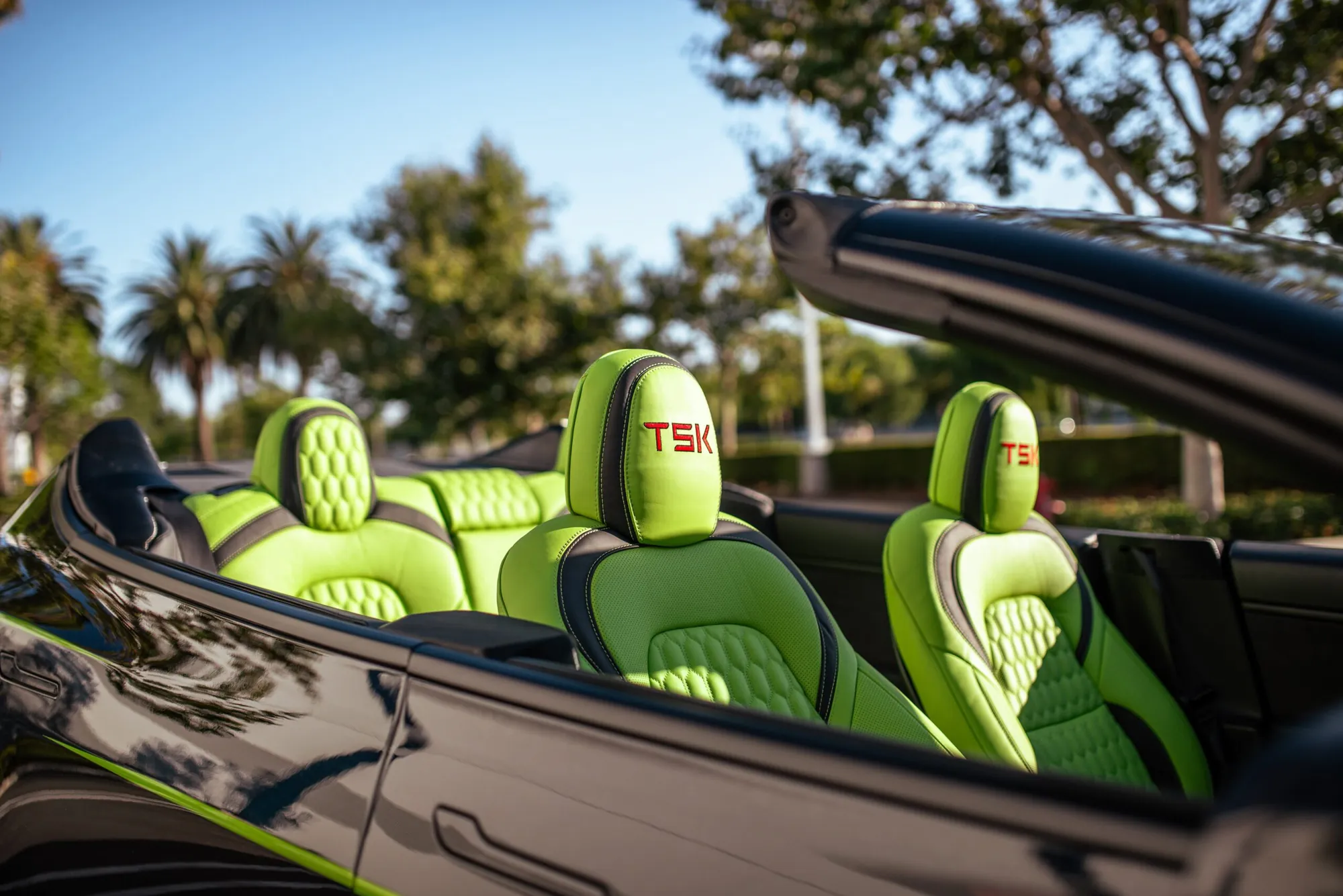 Roofless Tesla project: lime green leather seats with TSK stitching in the open cabin