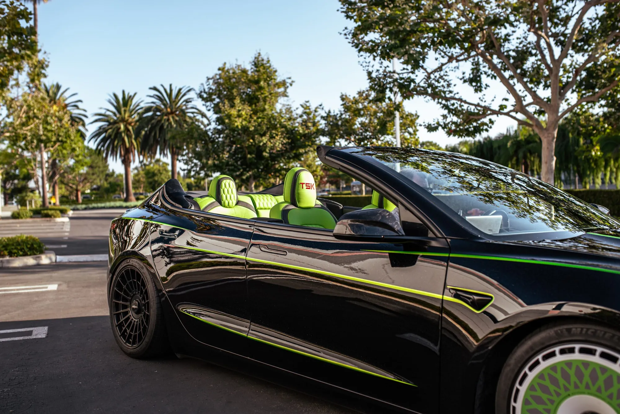 Roofless Tesla project: black Tesla Model 3 with no roof, lime green interior and green pinstripes