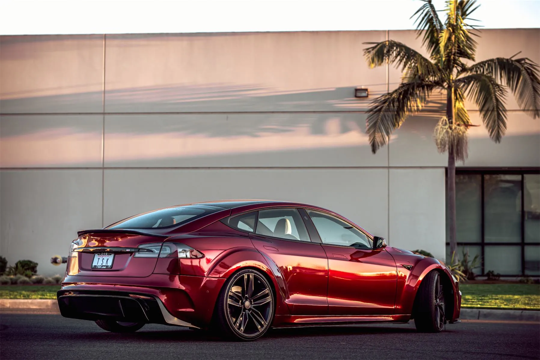 Wild Tesla project: rear side view of the red Tesla Model S widebody