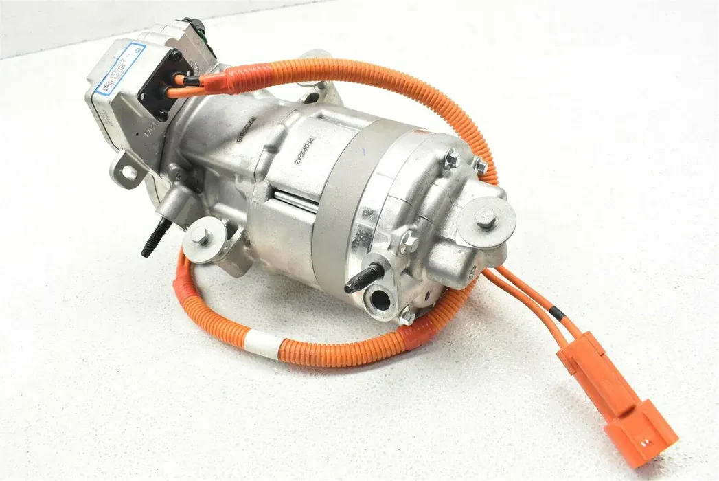 Electric vehicle AC compressor with orange high-voltage cables for Tesla HVAC repair