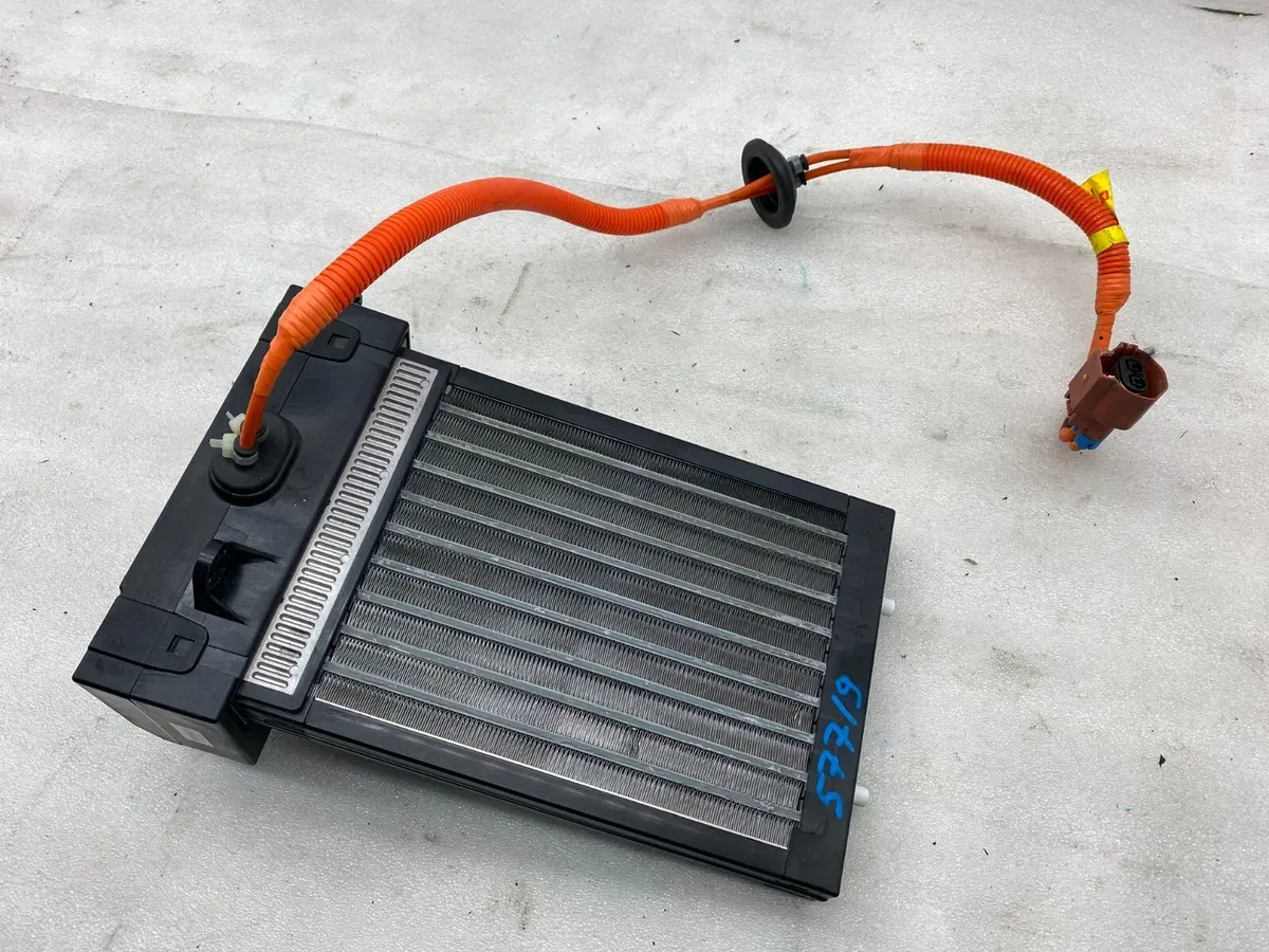 Tesla cabin heater core with orange high-voltage cables, removed for HVAC repair