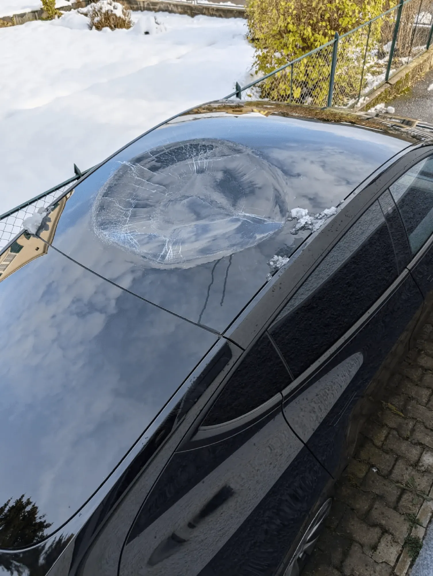 Cracked panoramic sunroof glass on black Tesla Model 3 needing repair in Irvine