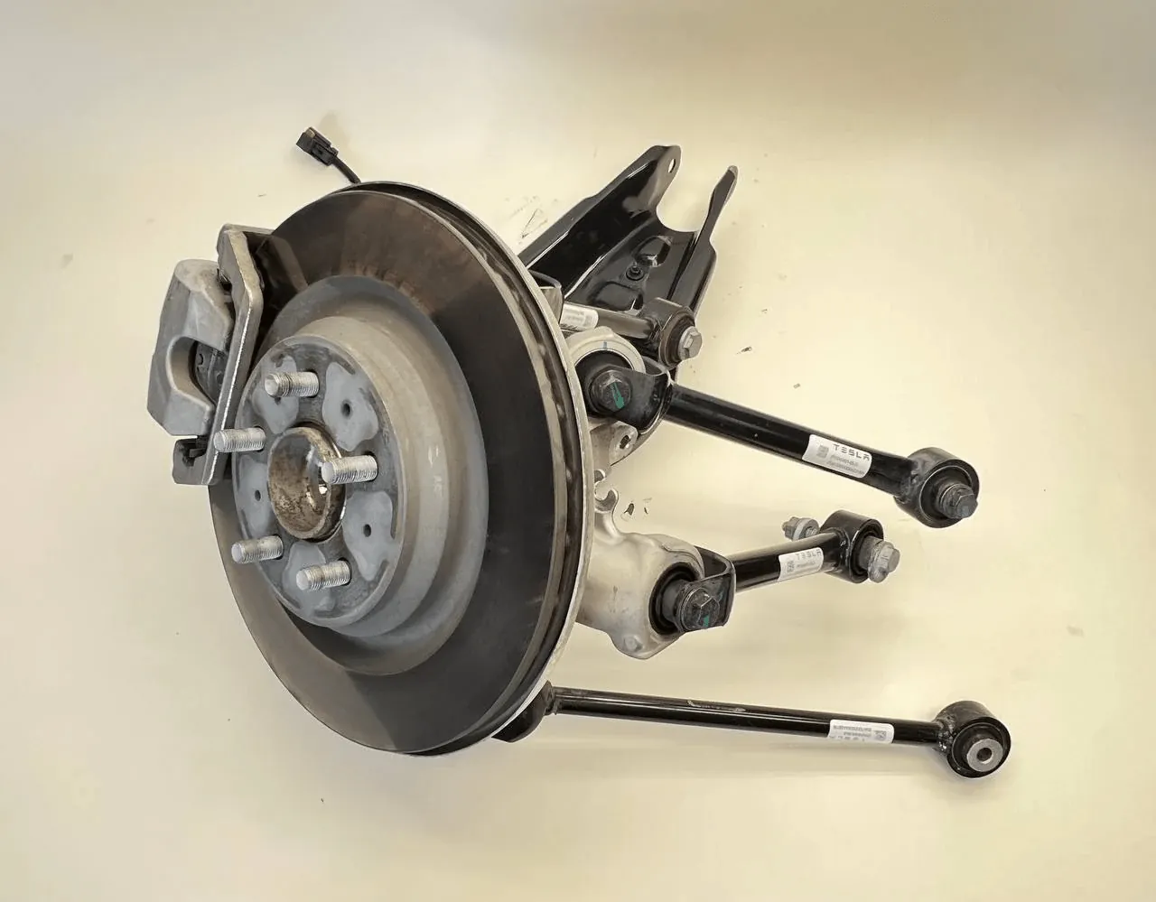 Tesla Model 3 rear suspension assembly with brake rotor and control arms, Irvine repair