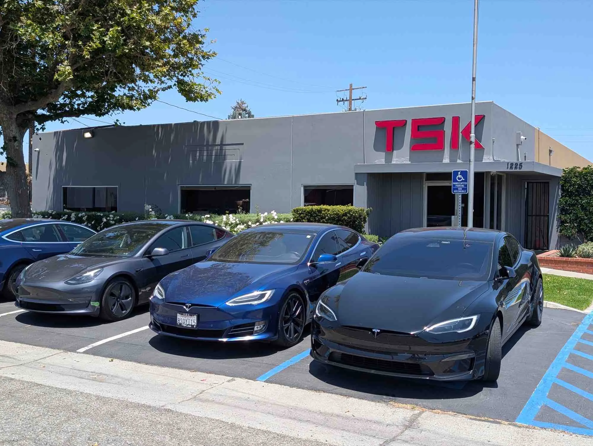 Black Tesla Model S parked outside TSK EV collision repair shop in Irvine