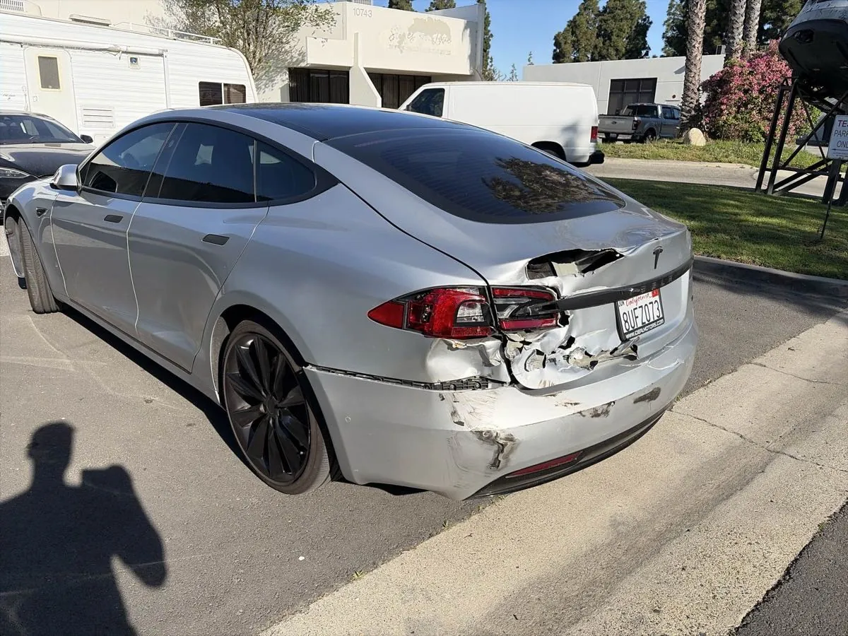 Silver Tesla Model S with rear bumper collision damage before repair in Irvine