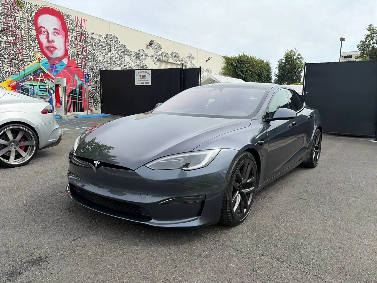 Gray Tesla Model S parked outside TSK's EV collision repair shop in Irvine