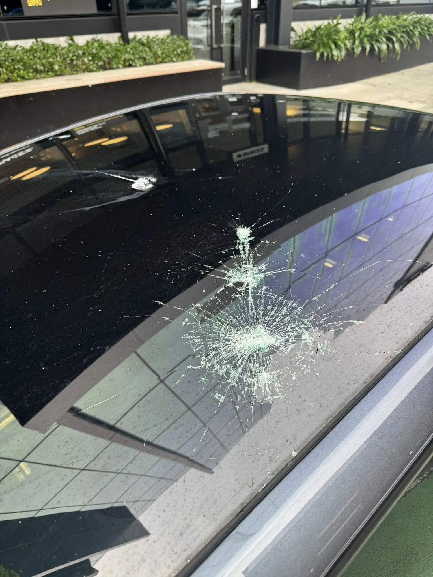 Cracked panoramic sunroof glass on Tesla Model Y before repair in Irvine