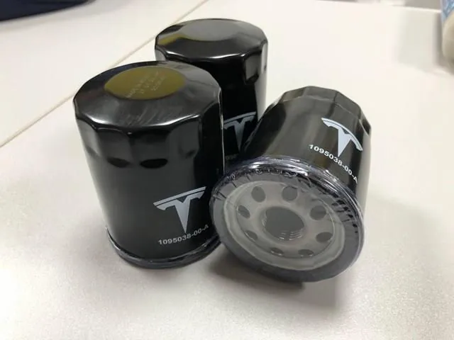 Three Tesla Model 3 reduction gear oil filters used during drive unit service at TSK
