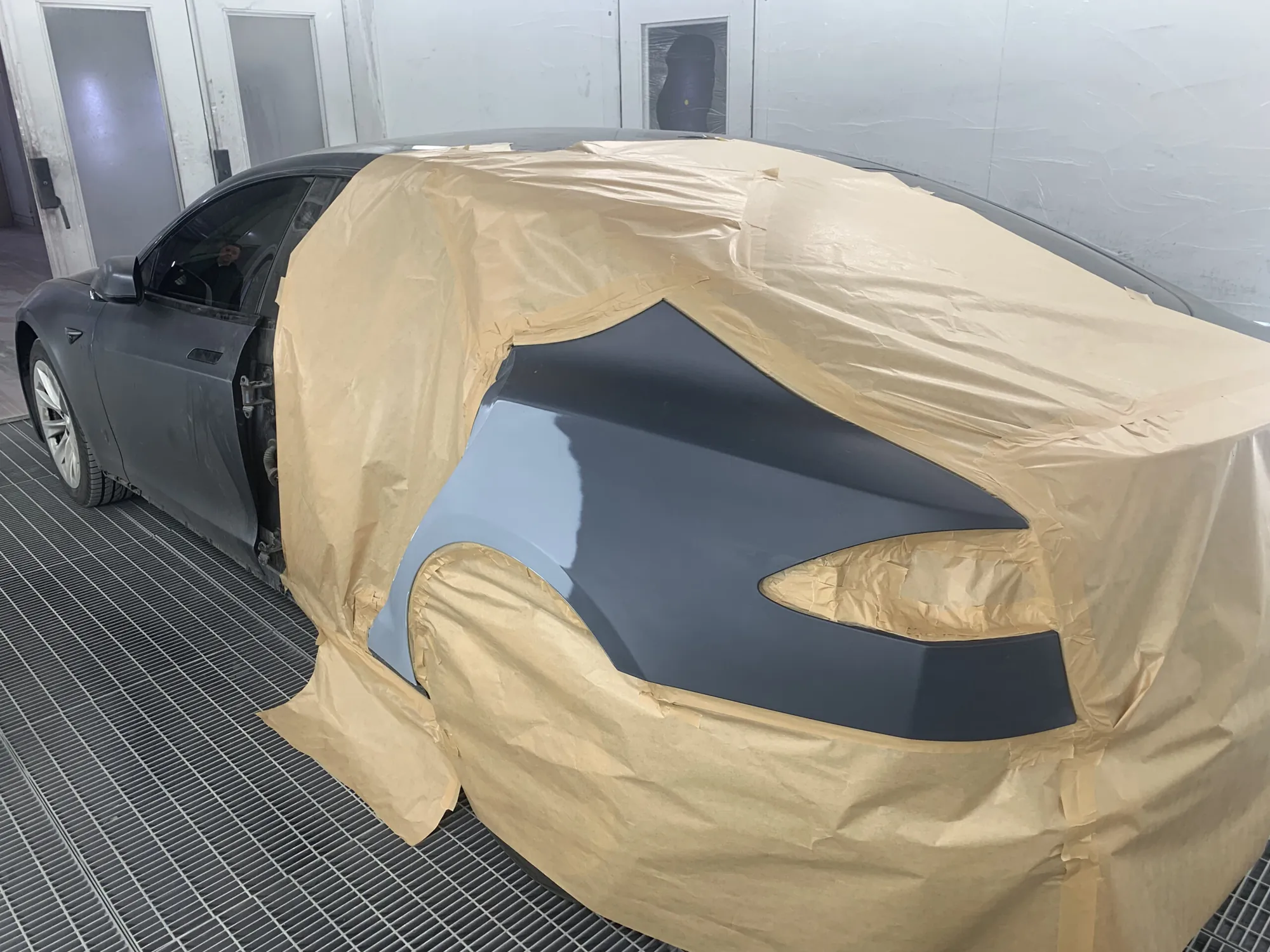 Tesla Model S masked with paper for paint prep in TSK's spray booth