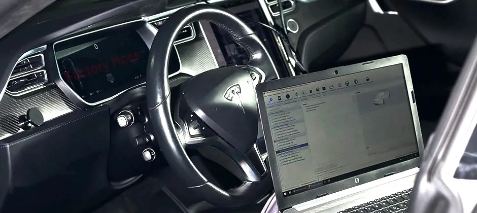 Tesla Model S dashboard in Factory Mode with diagnostic laptop for charging system troubleshooting