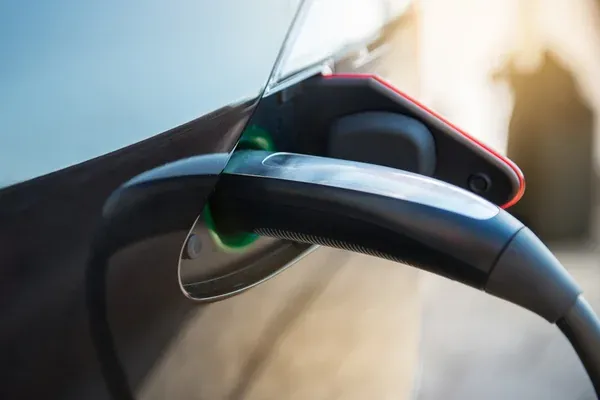 Charging cable plugged into Tesla Model S port during charging system troubleshooting