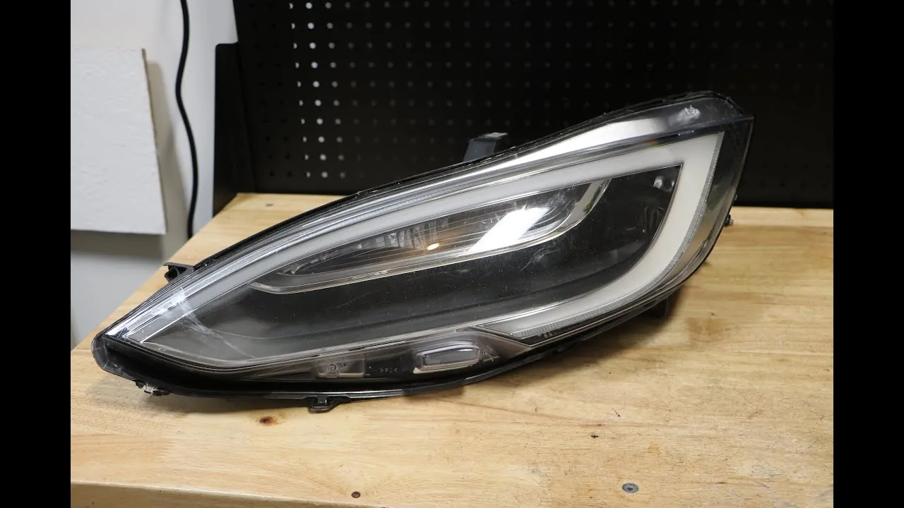 Tesla Model S headlight assembly on workbench for replacement at TSK