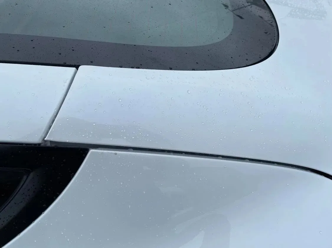 Close-up of Tesla Model S rear panel gaps and window trim after adjustment