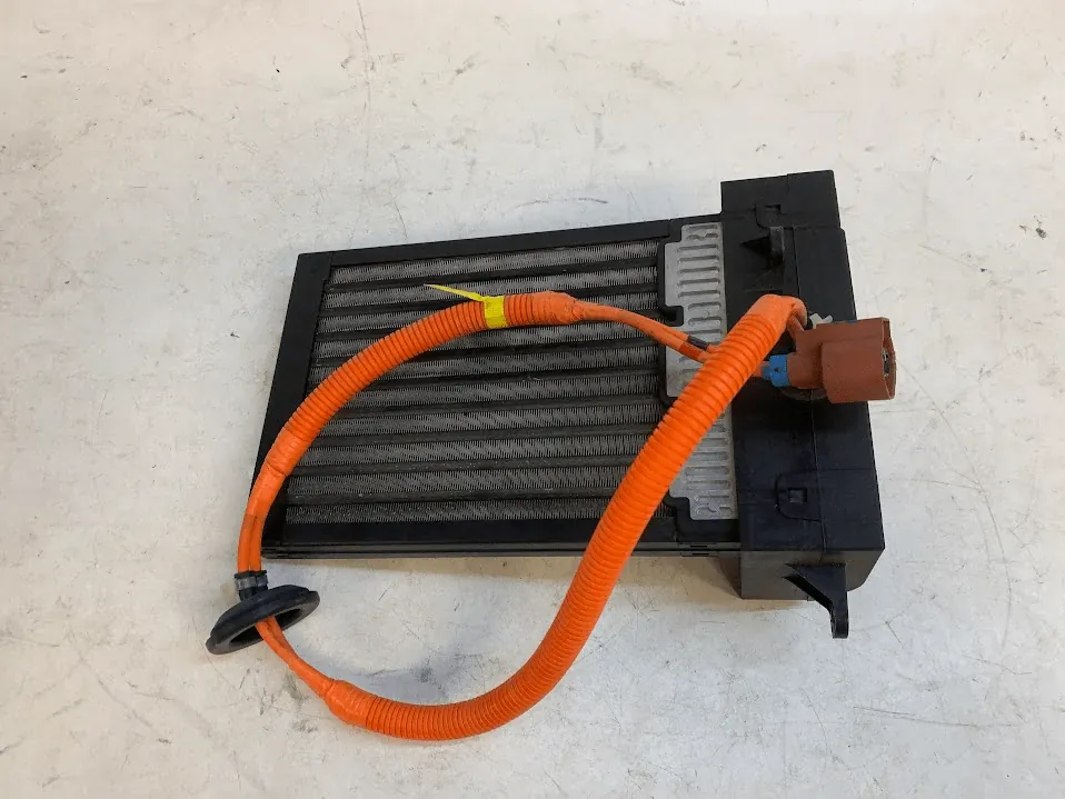 Tesla Model S cabin heater core with orange high-voltage cable and connector