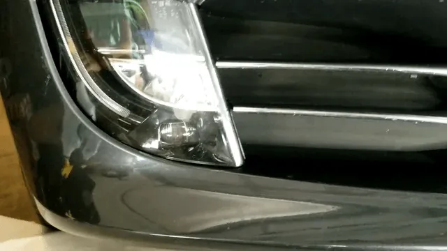 Close-up of Tesla Model S front headlight and bumper trim during inspection