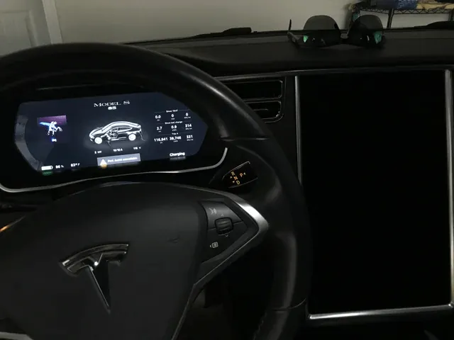 Tesla Model S dashboard with instrument cluster on and dark, unresponsive center MCU screen