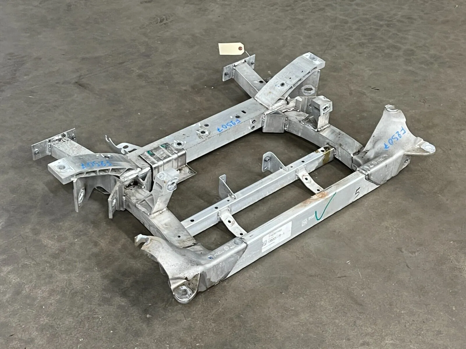 Tesla Model S front subframe assembly on shop floor, ready for replacement at TSK