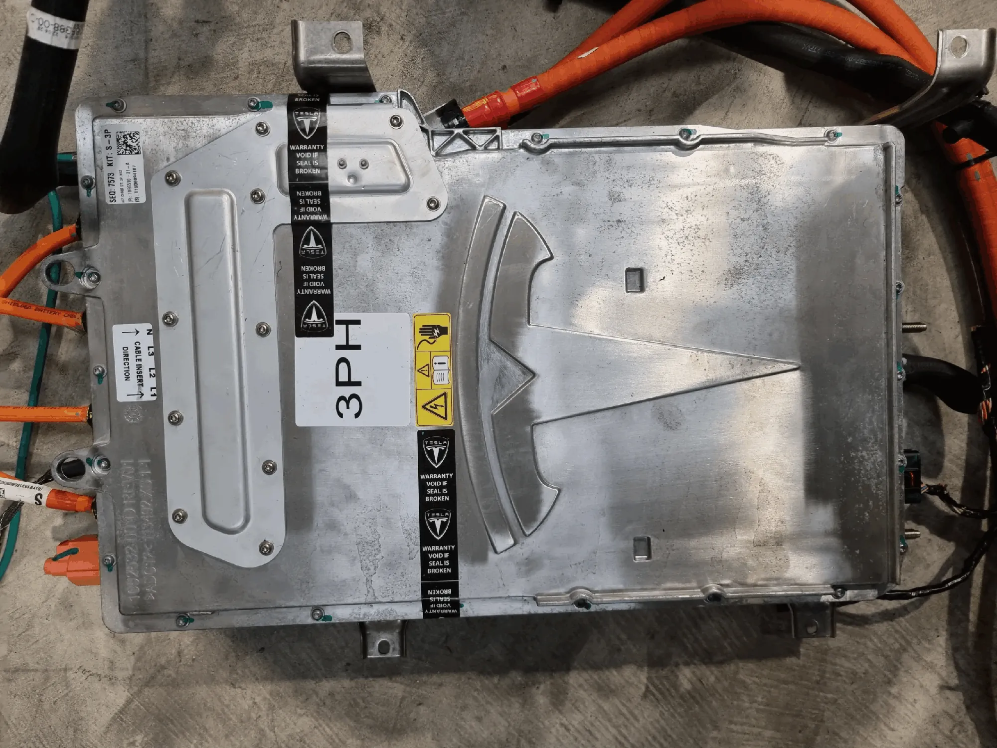 Tesla onboard charger unit with 3PH label, removed for charging system troubleshooting