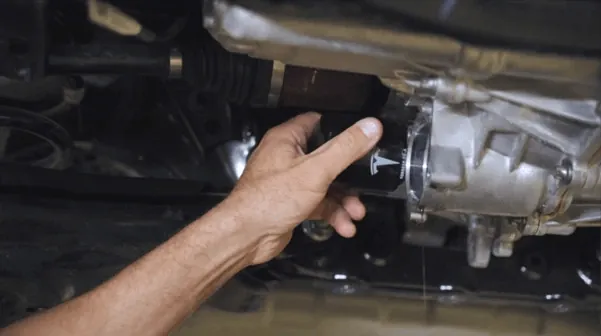 Technician inspecting Tesla Model X drive unit reduction gear during service at TSK