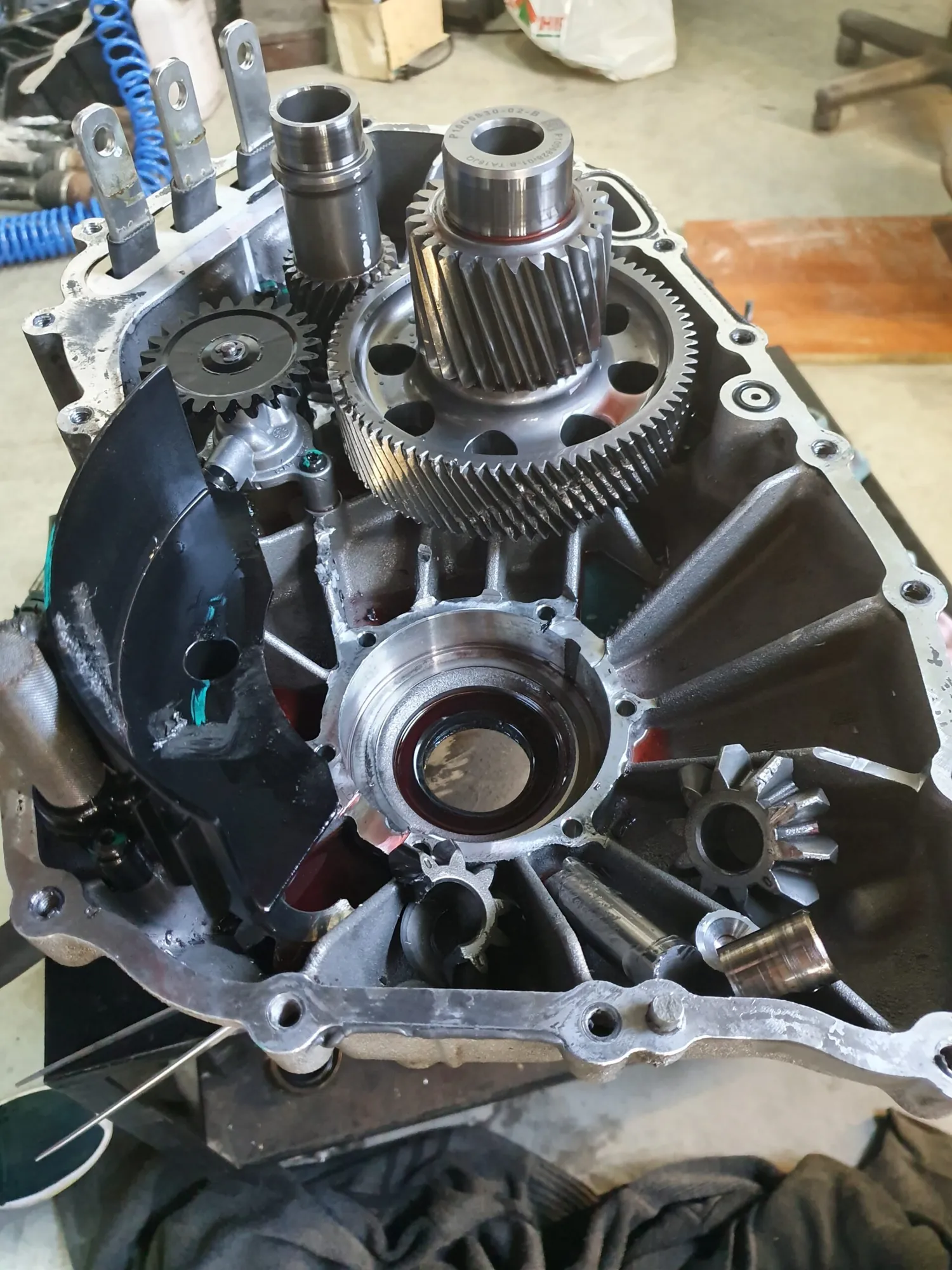 Tesla Model X drive unit disassembled, showing gears and differential during repair at TSK