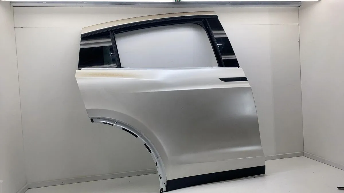 Tesla Model X rear door panel removed for repair at TSK collision shop