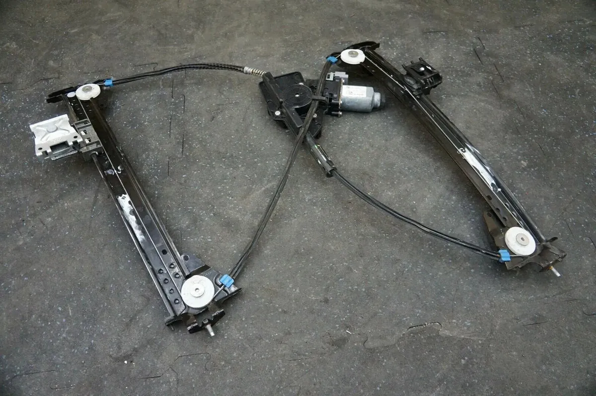 Tesla Model X window regulator assembly with motor, cables, and pulleys