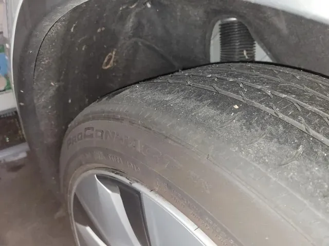 Close-up of Tesla Model X tire tread wear near wheel well and lug bolt