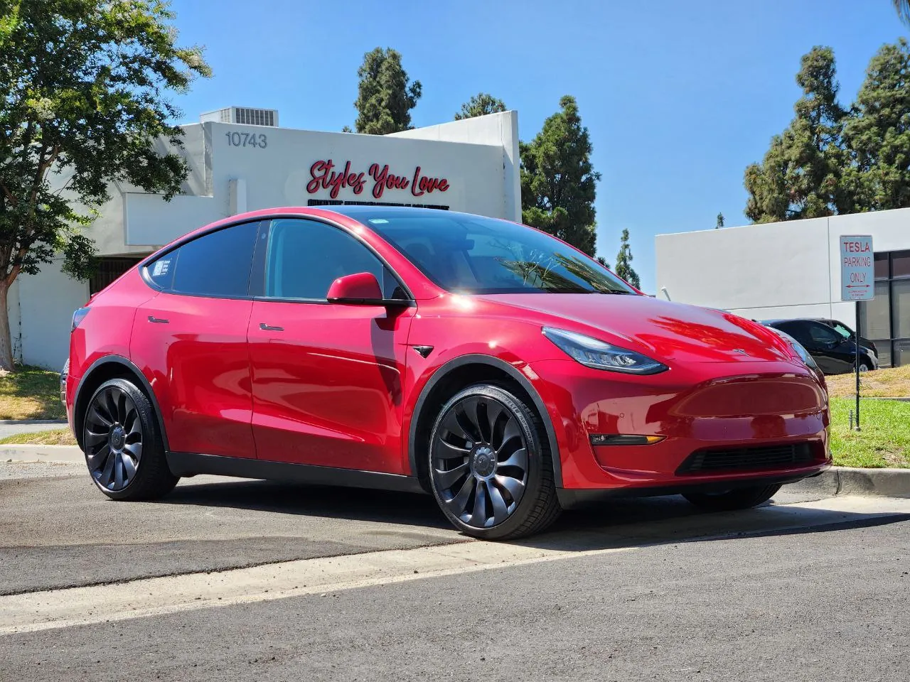 Red Tesla Model Y parked outside after body repair at TSK collision shop