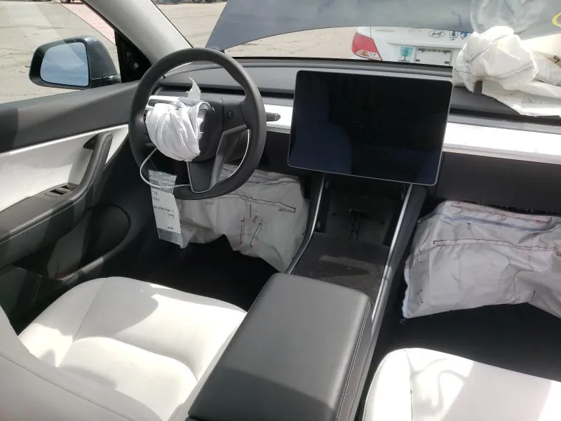Tesla Model Y interior with deployed airbags before diagnostic repair at TSK