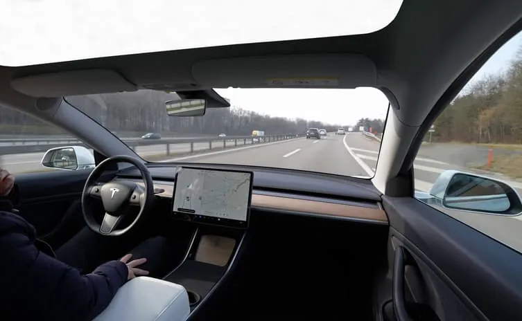 Tesla Model Y interior view during Autopilot programming and troubleshooting on highway