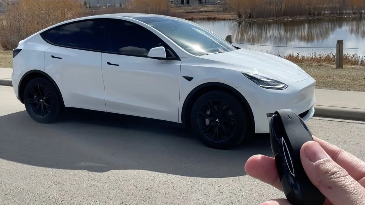 White Tesla Model Y with key fob being programmed, TSK Cypress service