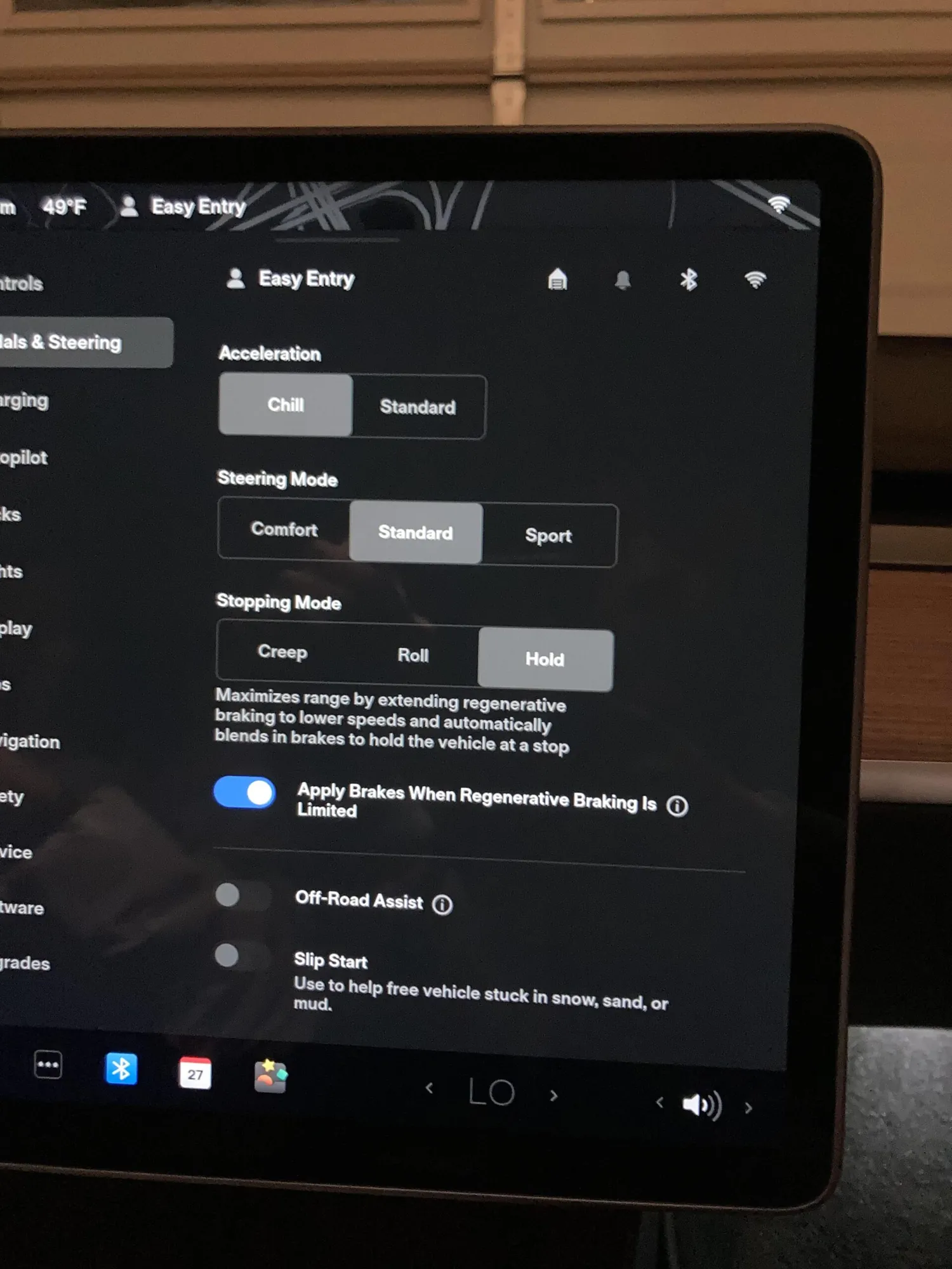 Tesla touchscreen showing Pedals & Steering settings with Hold stopping mode selected