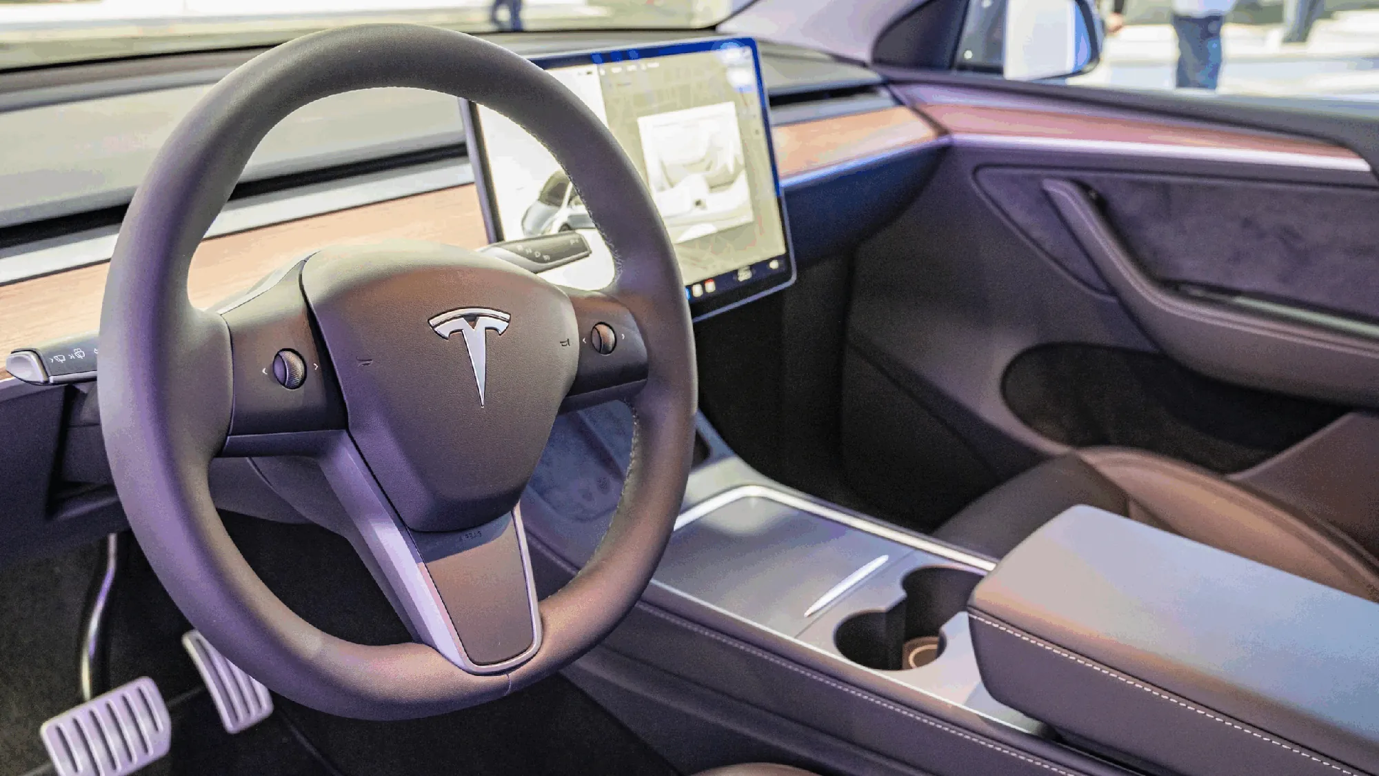 Tesla Model Y interior showing steering wheel and center console at TSK repair shop