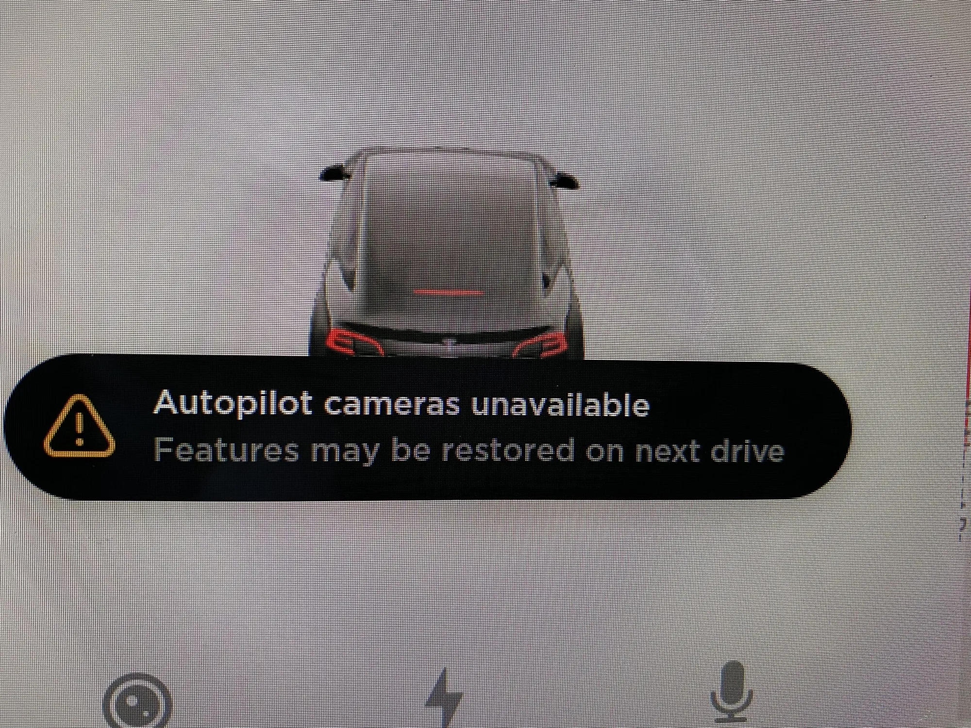 Tesla display showing "Autopilot cameras unavailable" warning needing programming service
